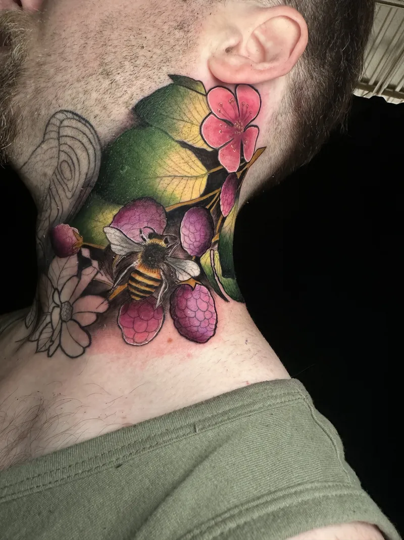 Colour neck tattoo with green leaves, pink blossoms and a bee