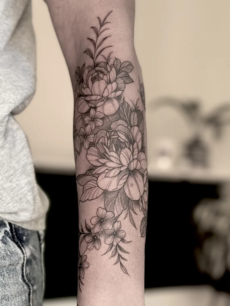Fine line floral forearm with peonies and wildflowers