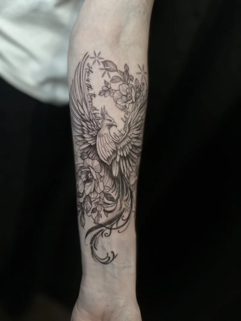 Fine line bird and blossoms on the inner forearm