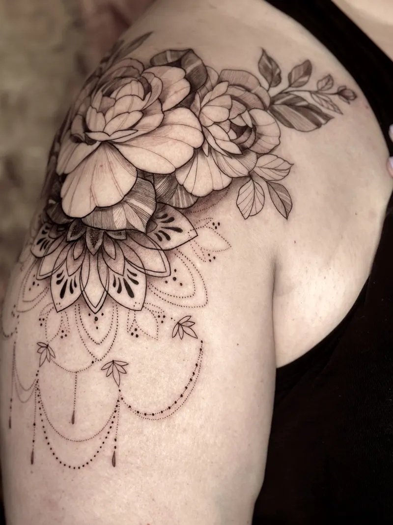 Dotwork mandala with roses and hanging chains on the shoulder